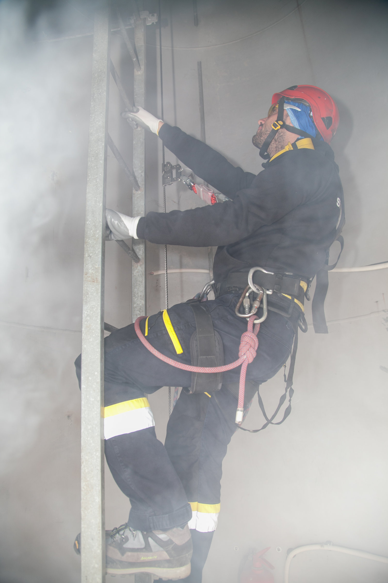 climbing in smoke filled training tower